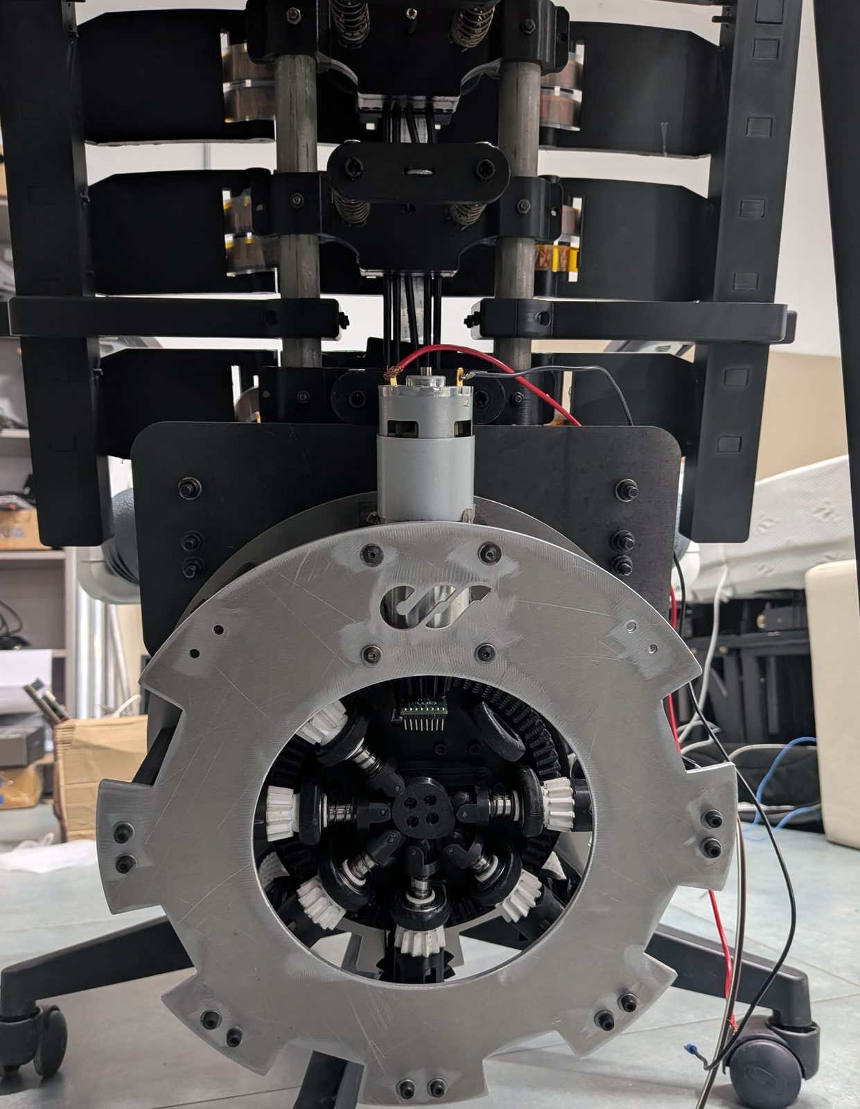 Early Flow prototype of the multiplexing powerhouse: a single DC motor feeding a central hub of radial bevel gearing, mounted under the seat.